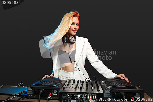 Image of Beautiful blonde DJ girl on decks - the party,