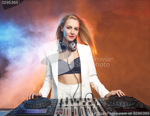 Image of Beautiful blonde DJ girl on decks - the party,