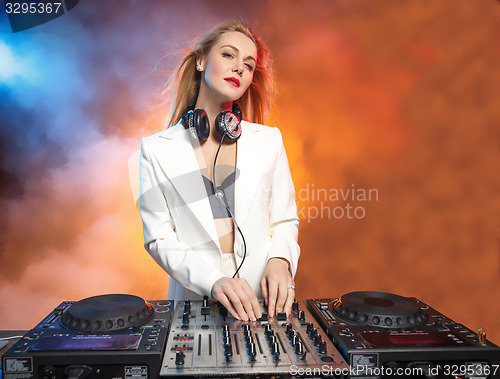 Image of Beautiful blonde DJ girl on decks - the party,