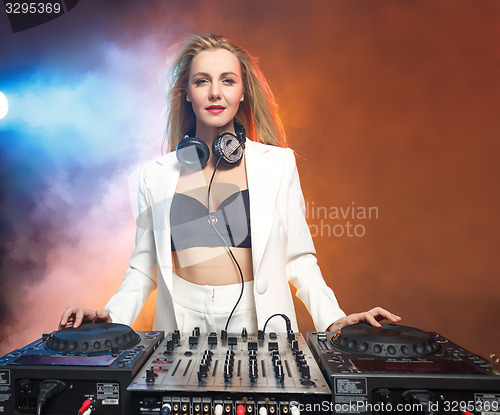 Image of Beautiful blonde DJ girl on decks - the party,