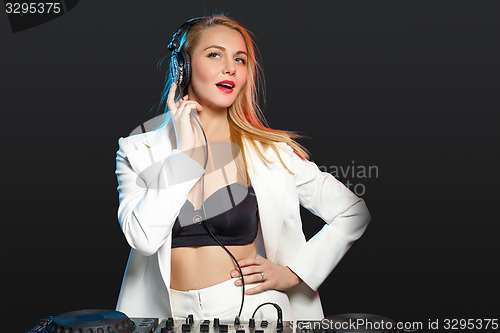 Image of Beautiful blonde DJ girl on decks - the party,