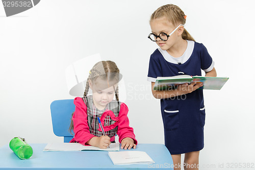 Image of Girl student teacher dictating dictation