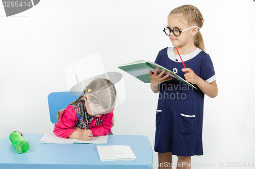 Image of Girl teacher reading assignment student