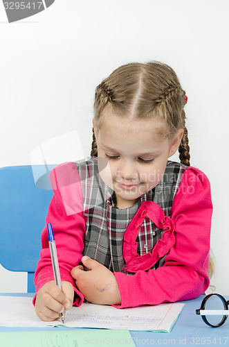 Image of Schoolgirl wrote in a notebook