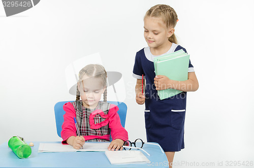 Image of Girl teacher during task checks correctness of its implementation