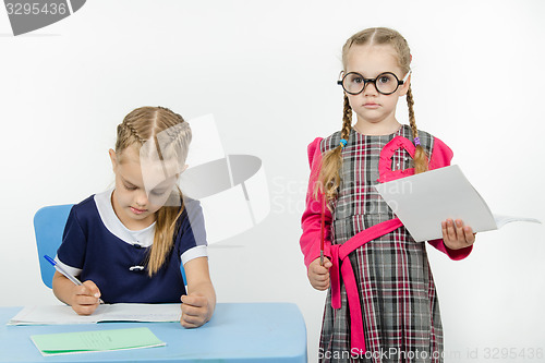 Image of Severe teacher standing at the student