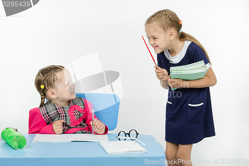 Image of Teacher and student happily smile at each other