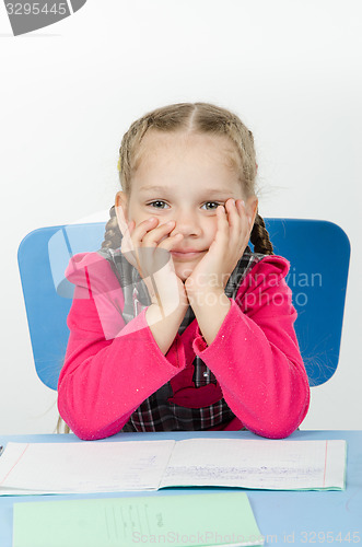 Image of Portrait of a pensive pupil at school desk