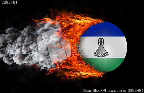 Image of Flag with a trail of fire and smoke - Lesotho