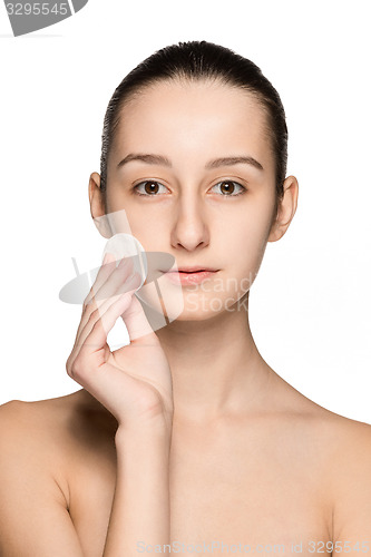 Image of skin care woman removing face with cotton swab pad