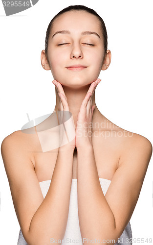 Image of Portrait of beautiful girl stroking her face with healthy skin 