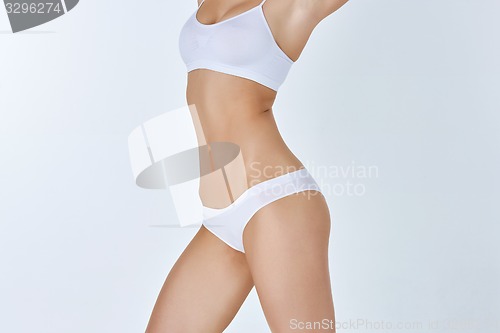 Image of Young, slim, healthy and beautiful woman in white lingerie 