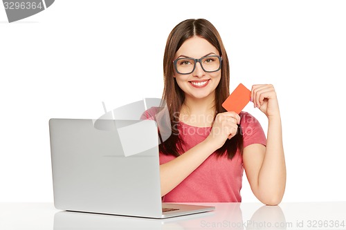 Image of smiling businesswoman with laptop and credit card