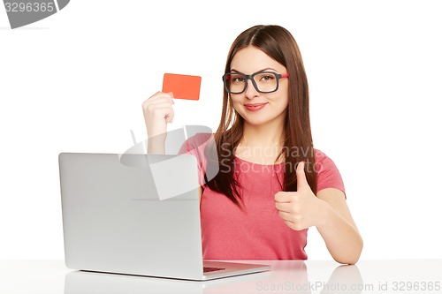 Image of smiling businesswoman with laptop and credit card