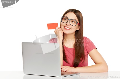 Image of smiling businesswoman with laptop and credit card