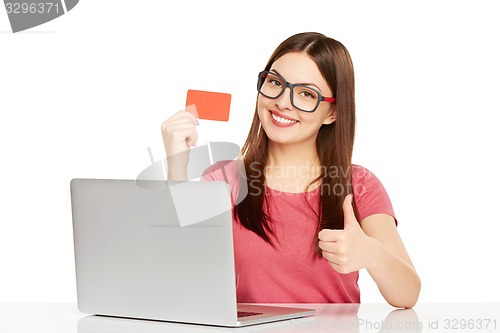 Image of smiling businesswoman with laptop and credit card