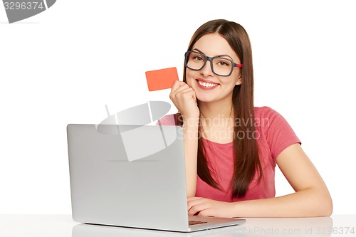 Image of smiling businesswoman with laptop and credit card