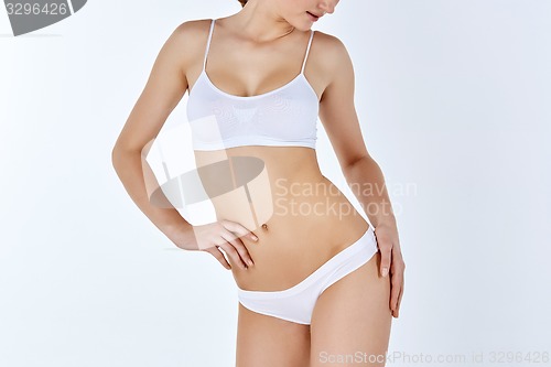 Image of Young, slim, healthy and beautiful woman in white lingerie 