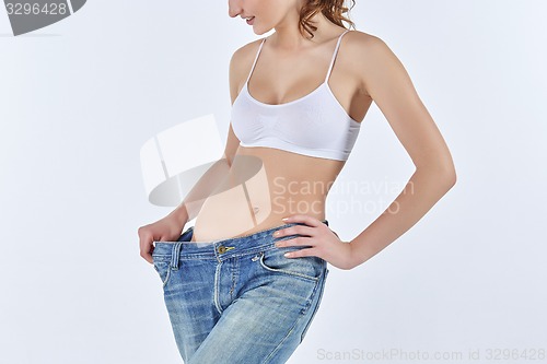 Image of Woman became skinny and wearing old jeans