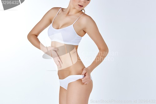 Image of Young, slim, healthy and beautiful woman in white lingerie 