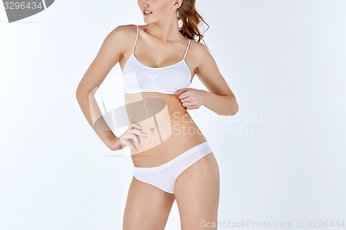 Image of Young, slim, healthy and beautiful woman in white lingerie 