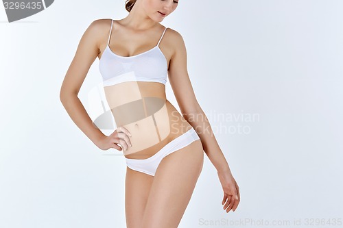 Image of Young, slim, healthy and beautiful woman in white lingerie 