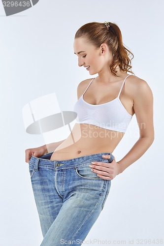 Image of Woman became skinny and wearing old jeans