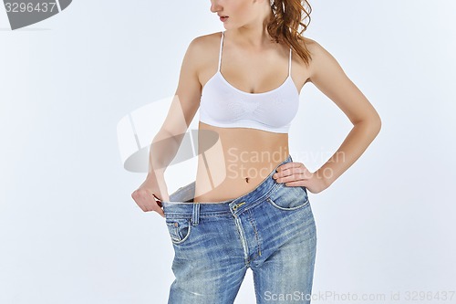 Image of Woman became skinny and wearing old jeans