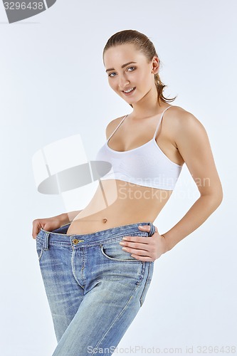 Image of Woman became skinny and wearing old jeans