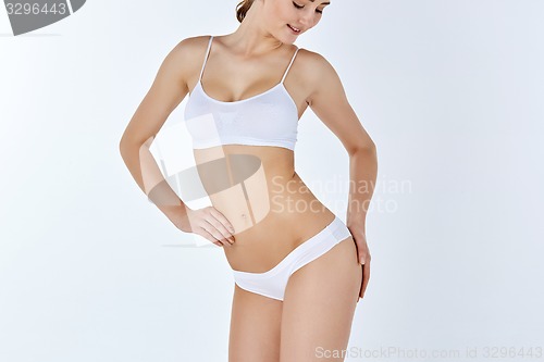 Image of Young, slim, healthy and beautiful woman in white lingerie 