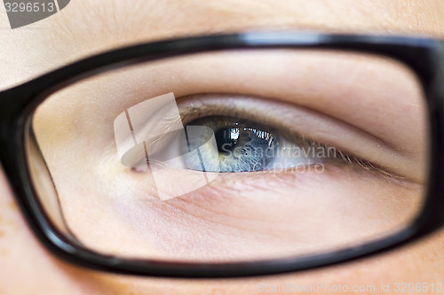 Image of Eye in glasses close up