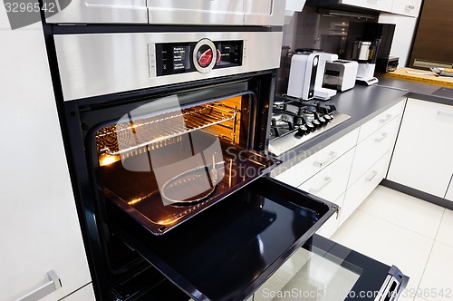 Image of Modern hi-tek kitchen, oven with door open