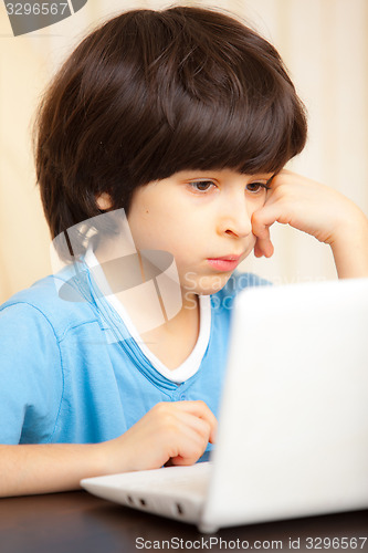 Image of child looking at a computer monitor