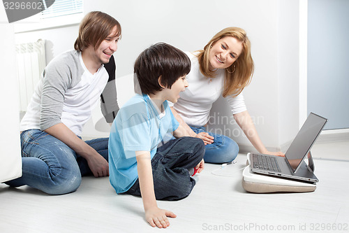 Image of Young parents with child