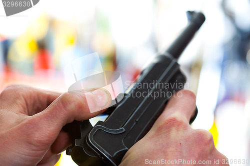 Image of Luger automatic pistol in a human hand