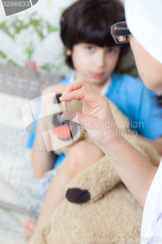 Image of doctor with pill and boy