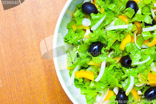 Image of Assorted salad of green leaf lettuce with squid and black olives