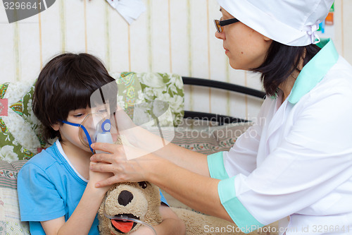 Image of doctor spends boy inhalation