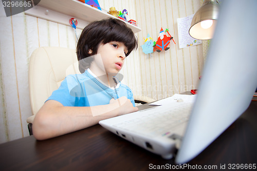 Image of child with computer, distance learning