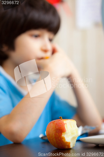 Image of bitten apple and a boy with computer