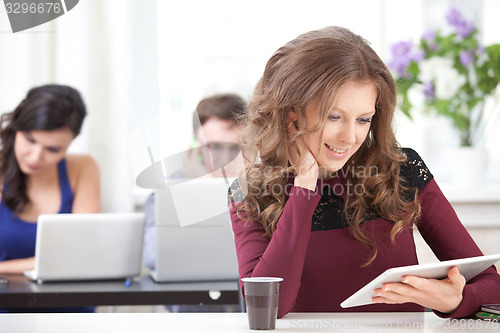 Image of smiling young girl with tablet