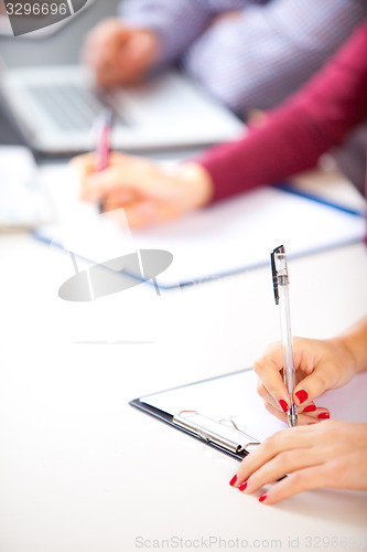 Image of Woman signing a contract