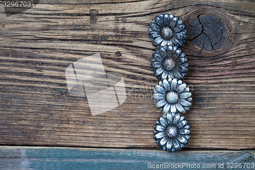 Image of four vintage buttons on wooden boards