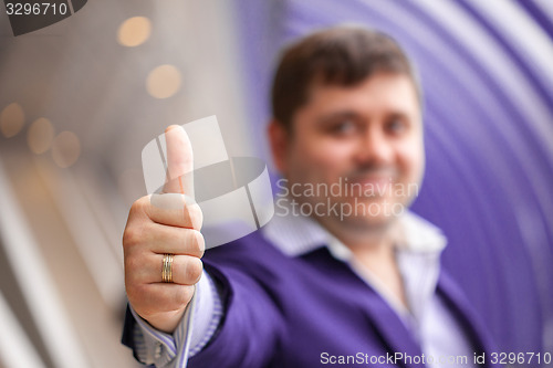 Image of businessman showing thumbs up