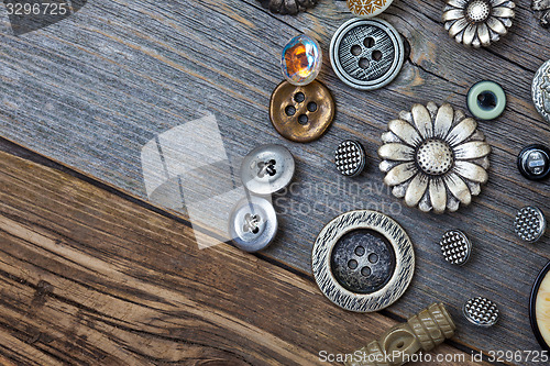 Image of vintage buttons on the aged wooden boards