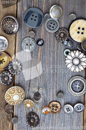 Image of vintage buttons on old wooden boards