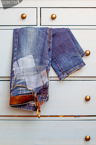 Image of old Jeans protrudes from the drawer