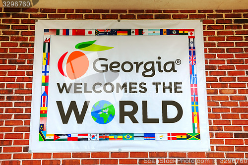 Image of Georgia welomes the world sign