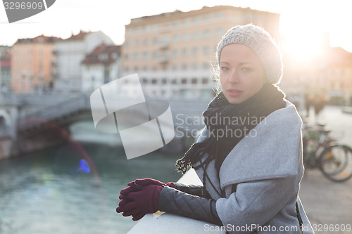 Image of Thoughtful woman outdoors on cold winter day.