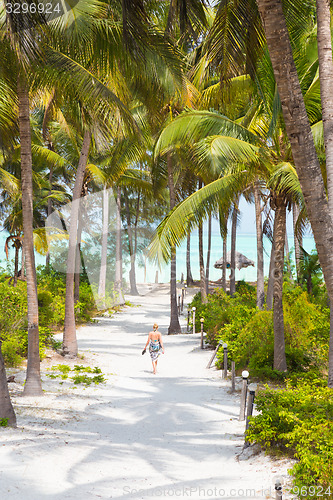 Image of Woman walking on Paje beach, Zanzibar.